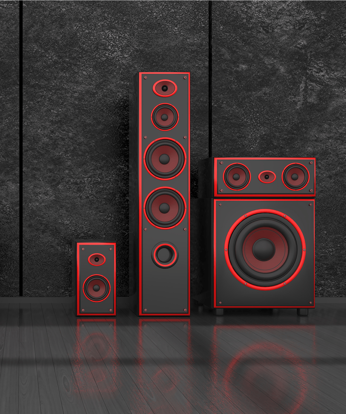 Black and red speakers on wooden floor.