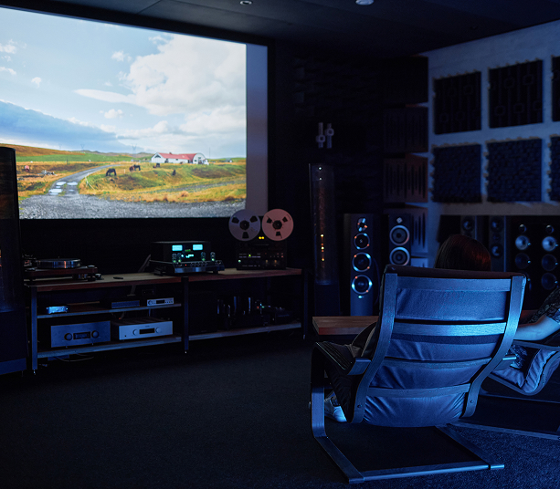 Person watching film in home theater.